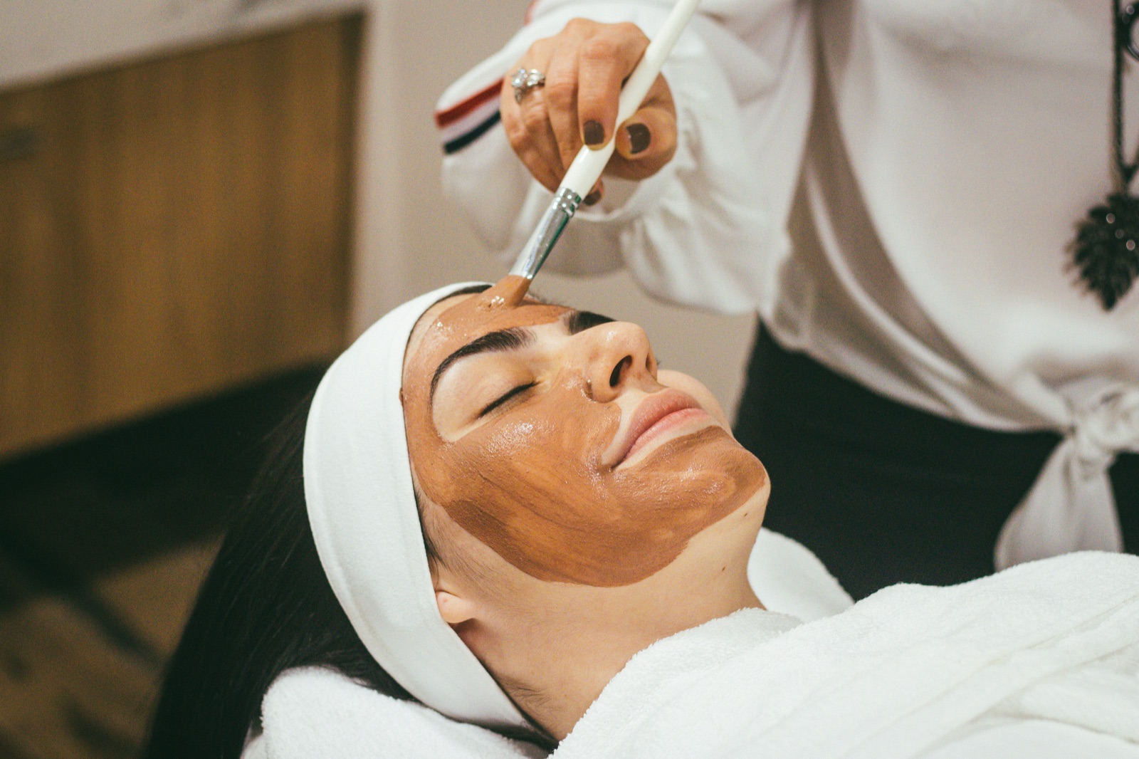 Aesthetician applying a facial treatment to a client at a medspa